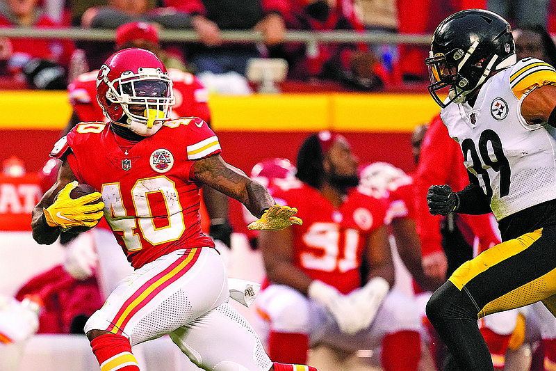 Chiefs running back Derrick Gore carries the ball as Steelers free safety Minkah Fitzpatrick pursues him during the first half of last Sunday’s game at Arrowhead Stadium in Kansas City.  (Associated Press)