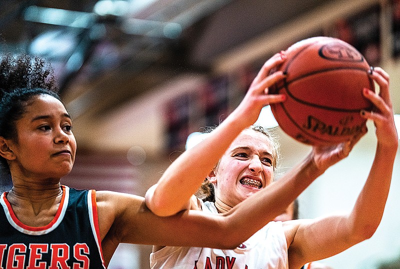 Jefferson City’s Lyssa Sportsman (right) reaches for the ball against Waynesville’s Brielle Garcia during Friday’s game at Fleming Fieldhouse. (Ethan Weston/News Tribune)