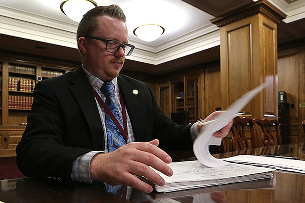 Josh Bridges, an election systems analyst with the Secretary of State's office, verifies signatures on nonpartisan judicial petitions on Friday, Jan. 7, 2022, at the state Capitol in Little Rock. 
(Arkansas Democrat-Gazette/Thomas Metthe)