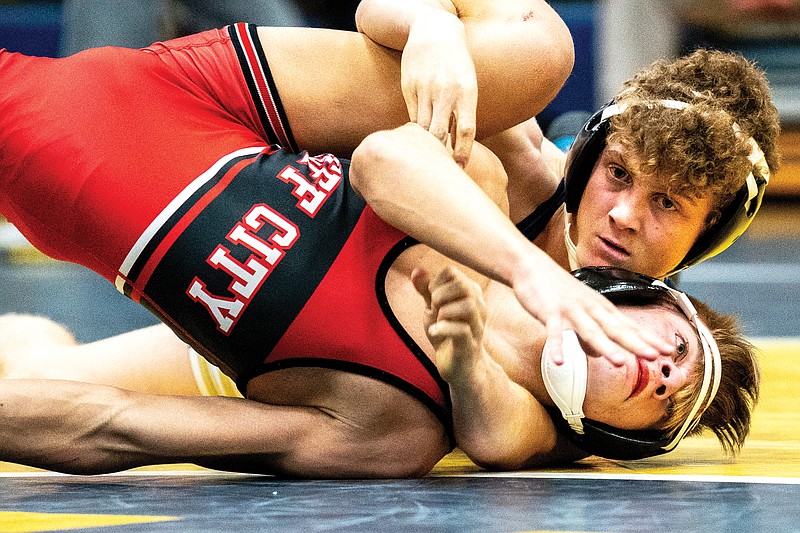 Carter Prenger of Helias tries to pin Jefferson City’s Dominic Stafford during the 120-pound match of Wednesday’s Central Missouri Activities Conference wrestling dual at Rackers Fieldhouse. Prenger won by technical fall for his 100th career victory, which also sealed a 32-31 dual win for the Crusaders. (Ethan Weston/News Tribune)