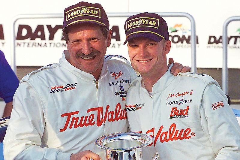 In this Feb. 18, 2000, file photo, Dale Earnhardt (left) hugs Dale Earnhardt Jr. in victory lane after the elder Earnhardt won the International Race of Champions round at the Daytona International Speedway in Daytona Beach, Fla. (Associated Press)