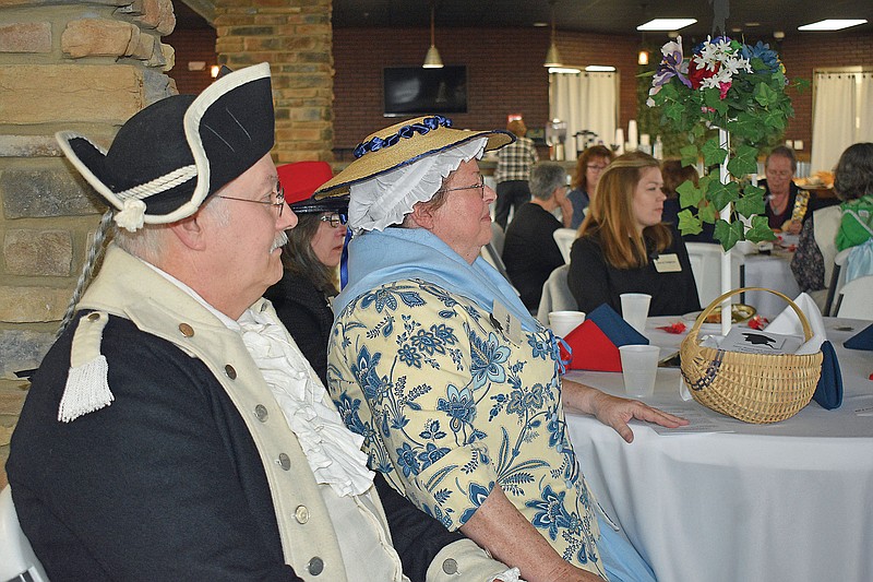 Jim and Debbie Baker, of Centertown, listen to a presentation Sunday during the 125th anniversary tea party for the Jane Randolph Jefferson Chapter of Daughters of the American Revolution. Jim is a member of the Sons of the American Revolution and Debbie is joining the local DAR chapter. (Gerry Tritz/News Tribune)
