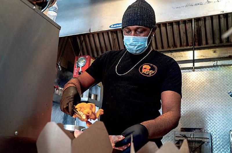 Brian Johnson scoops fries into boxes Friday, March 11, 2022, at Crazy Fry's in Jefferson City.