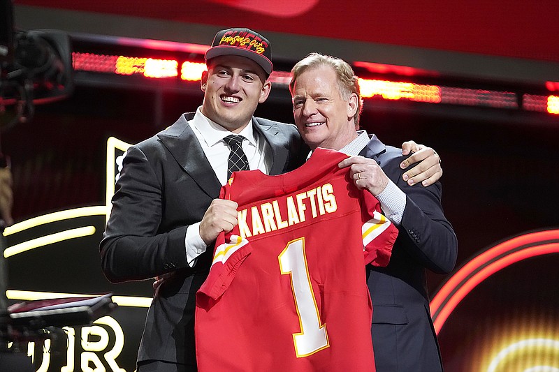 Purdue defensive end George Karlaftis and NFL commissioner Roger Goodell hold a team jersey after Karlaftis was chosen by the Chiefs with the 30th pick of the 2022 NFL Draft on Thursday in Las Vegas. (Associated Press)