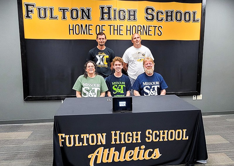 Fulton senior Shaun Wolfe is surrounded by family and coaches Friday in the Fulton High School library during his college signing ceremony to Missouri S&T. (Submitted by Fulton Public Schools)