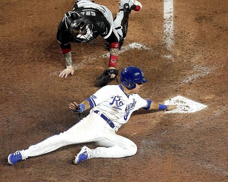 Nicky Lopez of the Royals beats the tag by White Sox catcher Yasmani Grandal to score on a two-run double by Whit Merrifield during the eighth inning of Monday night's game at Kauffman Stadium in Kansas City. (Associated Press)