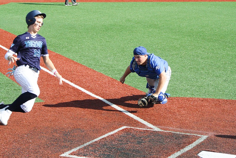 South Callaway senior catcher Jacob Lallier charges at Father Tolton’s Lucas Wietholder on a play at the plate Wednesday in the Class 3 District 7 championship game in Mokane. (Jeremy Jacob/FULTON SUN)