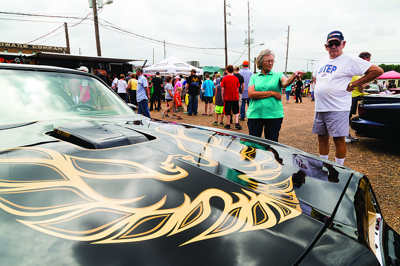 Auto enthusiasts look at Burt Reynolds' Trans Am at the Four States Auto Museum on June 17, 2017. The Burt Reynolds Institute for Film & Theatre brought several of his cars to show at the Bandit Run. (Gazette file photo by Joshua Boucher)