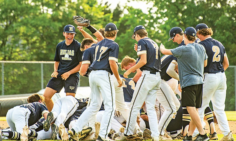 The Helias Crusaders celebrate with a dogpile following their Class 5 District 5 Tournament championship win Friday against Washington at the American Legion Post 5 Sports Complex. (Ken Barnes/News Tribune)