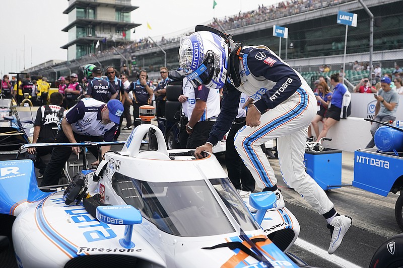 Alex Palou climbs into his car Saturday during qualifications for the Indianapolis 500 at Indianapolis Motor Speedway in Indianapolis. (Associated Press)