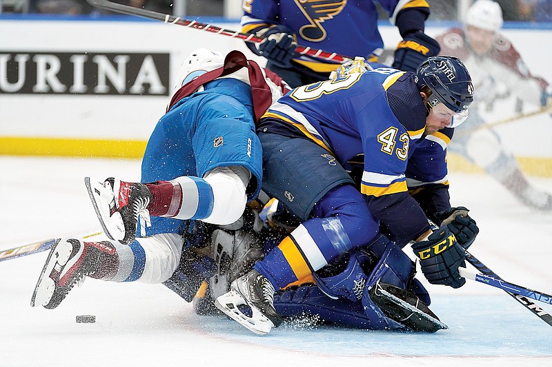 Nazem Kadri of the Avalanche falls on Blues goaltender Jordan Binnington behind Calle Rosen (43) of the Blues during the first period in Game 3 of their Western Conference second-round series Saturday night in St. Louis. (Associated Press)