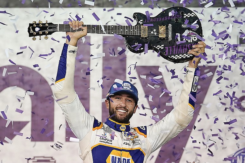 Chase Elliott holds the guitar presented to him Sunday after winning a NASCAR Cup Series race in Lebanon, Tenn. (Associated Press)