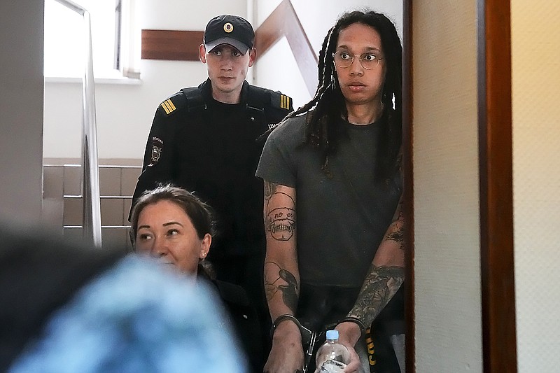 WNBA star and two-time Olympic gold medalist Brittney Griner is escorted to a courtroom for a hearing Monday in Khimki just outside Moscow. (Associated Press)