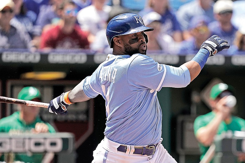 Carlos Santana of the Royals hits a two-run single during the sixth inning of Sunday afternoon’s game against the Athletics at Kauffman Stadium in Kansas City. (Associated Press)