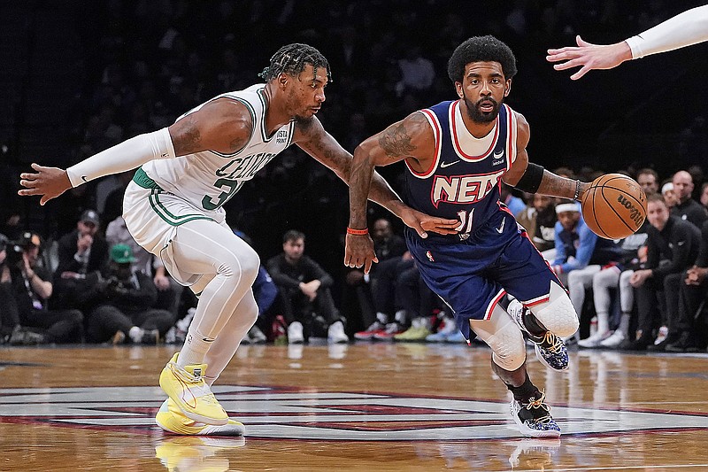 In this April 25 file photo, Nets guard Kyrie Irving drives past Celtics guard Marcus Smart during the first half of Game 4 of an Eastern Conference first-round playoff series in New York. (Associated Press)