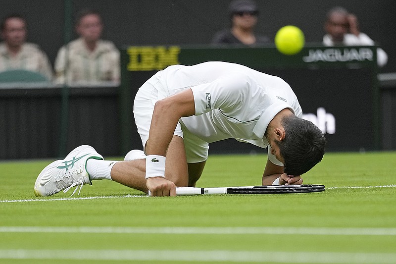 Novak Djokovic slips as he plays Kwon Soonwoo in Monday men's first-round singles match on Day 1 of the Wimbledon Tennis Championships in London. (Associated Press)