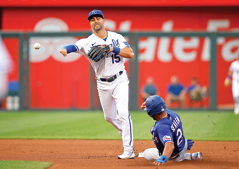 Marcus Semien of the Rangers is out at second as Royals second baseman Whit Merrifield throws to first for a double play during the first inning of Monday night’s game at Kauffman Stadium in Kansas City. (Associated Press)