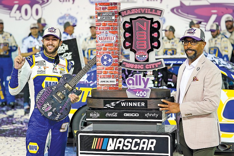 Nashville Superspeedway President Erik Moses presents Chase Elliott with his trophy after winning Sunday's NASCAR Cup Series race in Lebanon, Tenn. (Associated Press)