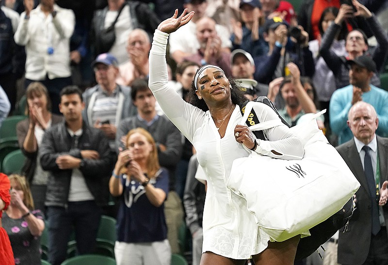 Serena Williams waves as she leaves the court Tuesday's after losing to Harmony Tan in a first-round women's singles match on Day 2 of the Wimbledon Tennis Championships in London. (Associated Press)