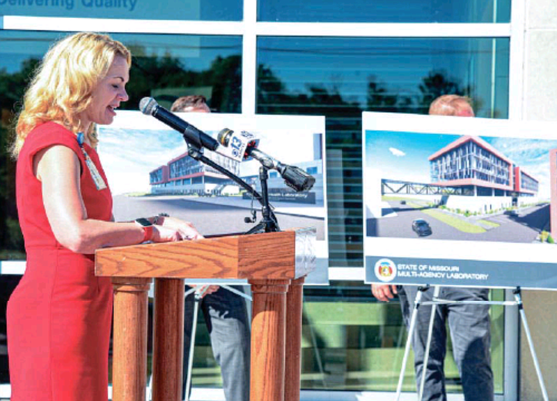 Laura Naught, deputy director of the Department of Health and Senior Services, delivers details Thursday about a new state health and crime lab, shown in renderings in the background.