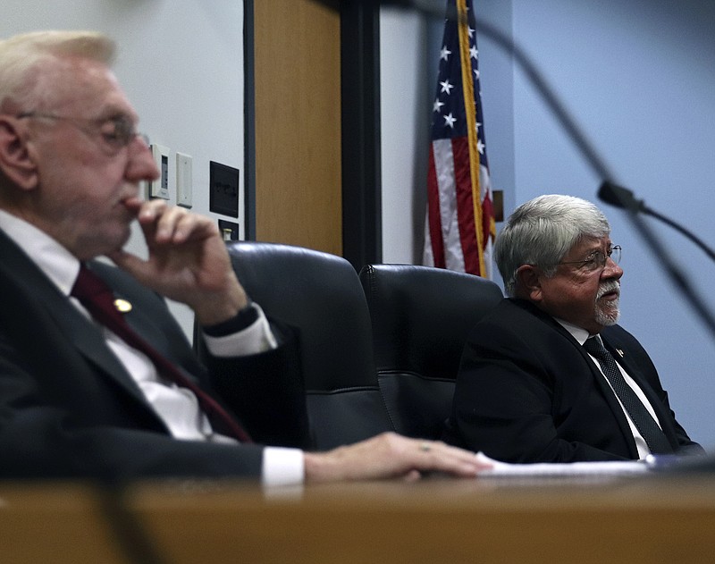 Candidates Rudy Veit, left, and George Bacon listen to a question at the House District 59 forum sponsored by the News Tribune.