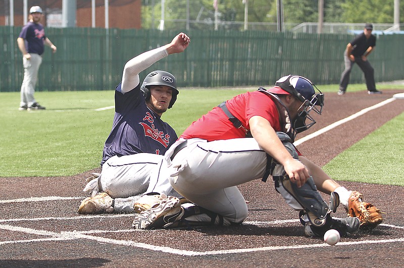 Jaden Kolb of the Jefferson City American Legion Post 5 Seniors slides into home plate to score a run as the ball gets away from St. Joseph Post 11 catcher Matthew Caudill during Thursday’s championship game of the Missouri American Legion AAA State Tournament at Liberty Park in Sedalia. (Greg Jackson/News Tribune)