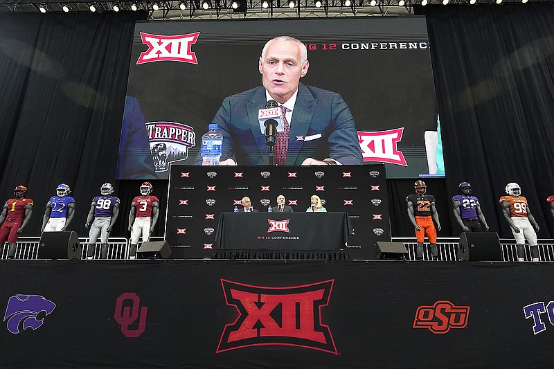 In this July 13 file photo, incoming Big 12 Conference commissioner Brett Yormark (center) speaks with outgoing commissioner Bob Bowlsby (left) and Baylor president Linda Livingstone looking on during a news conference opening the Big 12 Media Days in Arlington, Texas. (Associated Press)