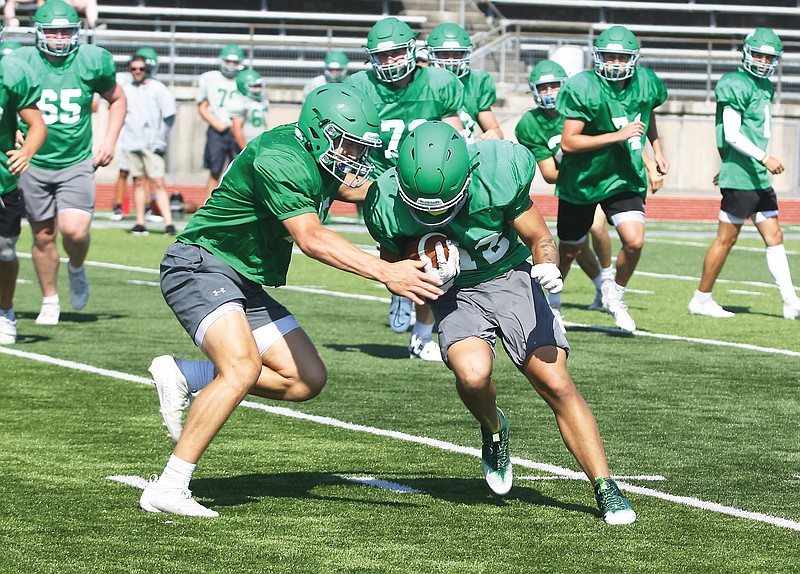 Blair Oaks linebacker Brady Kerperin (left) races in to make a tackle against running back Elijah Luckett during Saturday’s scrimmage at the Falcon Athletic Complex in Wardsville. (Greg Jackson/News Tribune)