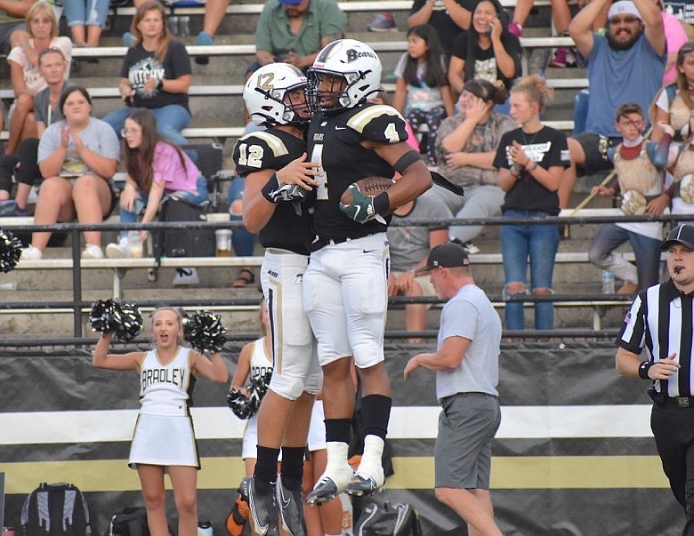 Staff photo by Patrick MacCoon / Bradley Central’s Alex Walker (12) and J’Alan Terry (4) celebrate their touchdown connection.