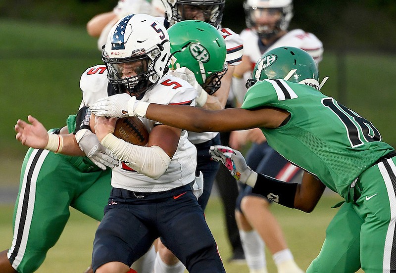 Staff photo by Robin Rudd / Heritage's Landon Cansler (5) breaks a tackle during Friday's game at East Hamilton.