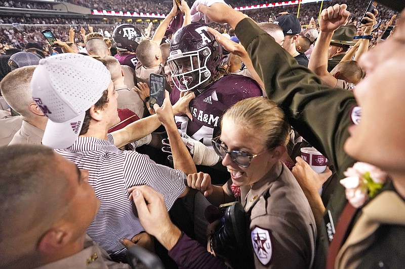 In this Oct. 9, 2021, file photo, Texas A&M students celebrate with Texas A&M defensive lineman Isaiah Raikes as they pack Kyle Field after upsetting Alabama 38-41 in a game at College Station, Texas. (Associated Press)