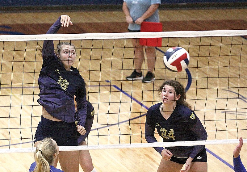 Helias middle hitter Summer Hake (left) tips the ball over the net during last season’s match against Fatima at Rackers Fieldhouse. (Greg Jackson/News Tribune)