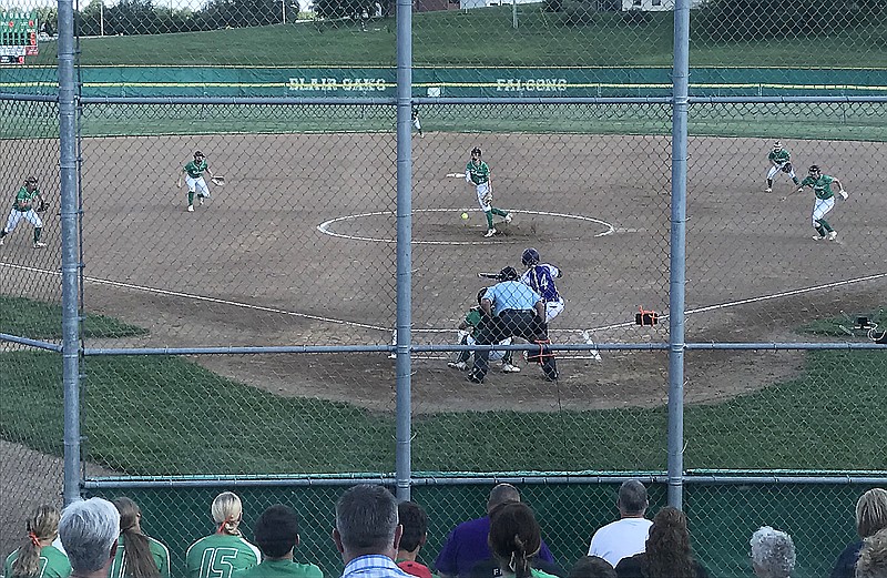 Blair Oaks pitcher Olivia Moyer delivers the ball to the plate to Hallsville's Kristen Jones during the first inning of Wednesday's game at the Falcon Athletic Complex in Wardsville. (Greg Jackson/News Tribune)