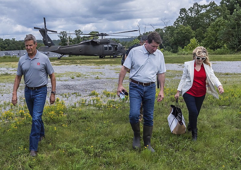 Alan Poizner/The Tennessean via AP, Pool / Gov. Bill Lee and Sens. Bill Hagerty and Marsha Blackburn exit a Tennessee National Guard UH-60 Black Hawk helicopter after landing in Waverly, Tenn., Sunday, Aug. 22, 2021, following heavy flooding in the area.