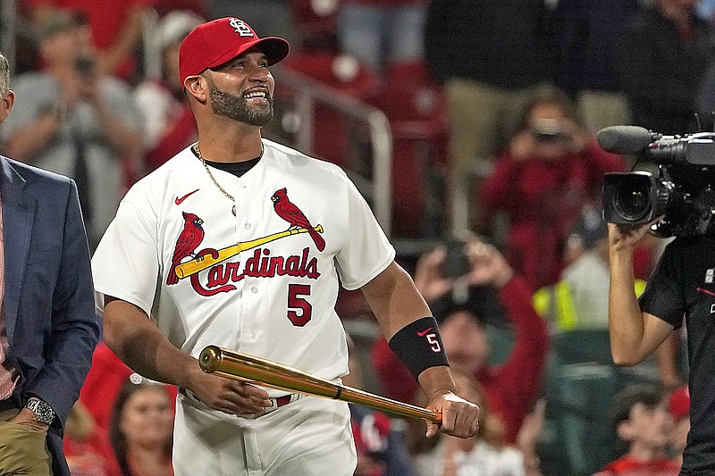 Albert Pujols of the Cardinals smiles during a ceremony honoring the recent hitting of his 700th career home run before the start of Friday night's game against the Pirates at Busch Stadium in St. Louis. (Associated Press)