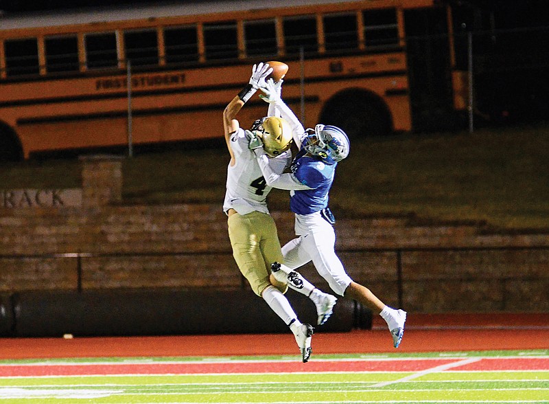 Helias linebacker Maddox Alfultis intercepts a pass in front of Capital City wide receiver Cameron Harris during Friday night’s game at Adkins Stadium. (Eileen Wisniowicz/News Tribune)