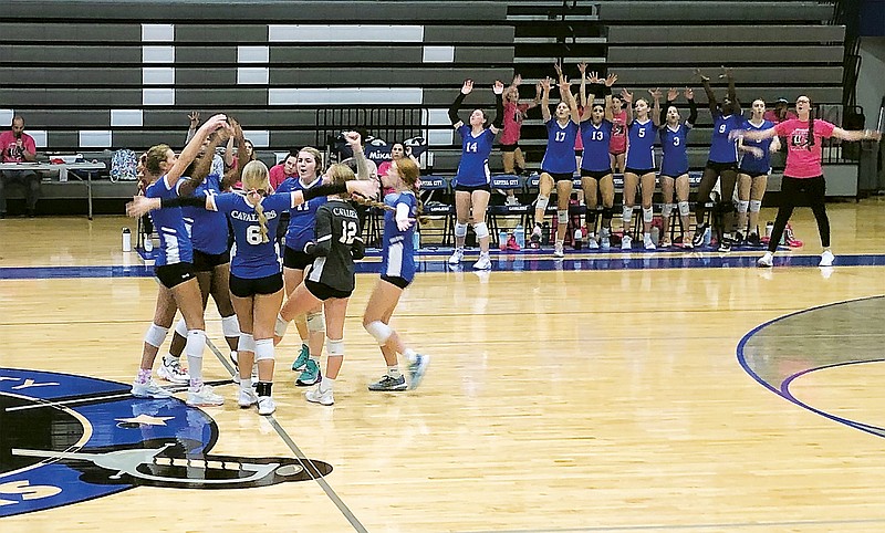 The Capital City Lady Cavaliers celebrate after a point during Tuesday night's Central Missouri Activities Conference match against the Jefferson City Lady Jays at Capital City High School. (Trevor Hahn/News Tribune)