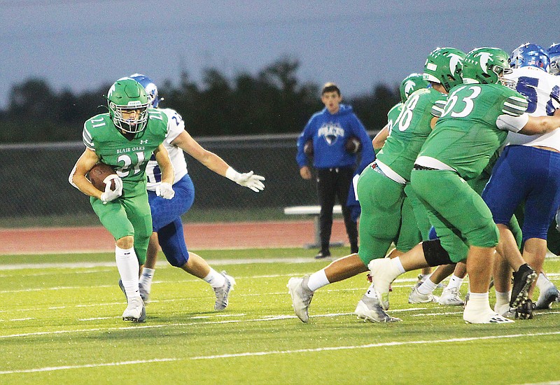 Blair Oaks running back Hayden Lackman finds a running lane behind the blocking of his offensive line during last month’s game against Boonville at the Falcon Athletic Complex in Wardsville. (Gracen Gaskins/News Tribune)