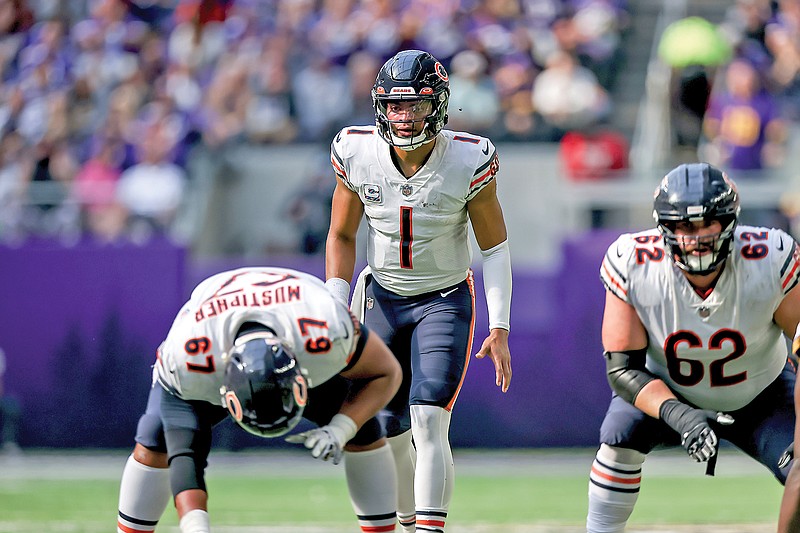 Chicago Bears quarterback Justin Fields runs against the Washington  Commanders in the second half of an NFL football game in Chicago, Thursday,  Oct. 13, 2022. The Commanders defeated the Bears 12-7. (AP