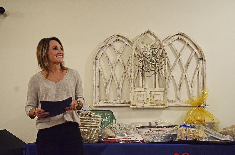 CASA Executive Director Gina Clement hands out pins and gift baskets Thursday at the CASA Volunteer Recognition Dinner. Clement recognized volunteers who started in 2022, as well as volunteers who have served for numerous years.