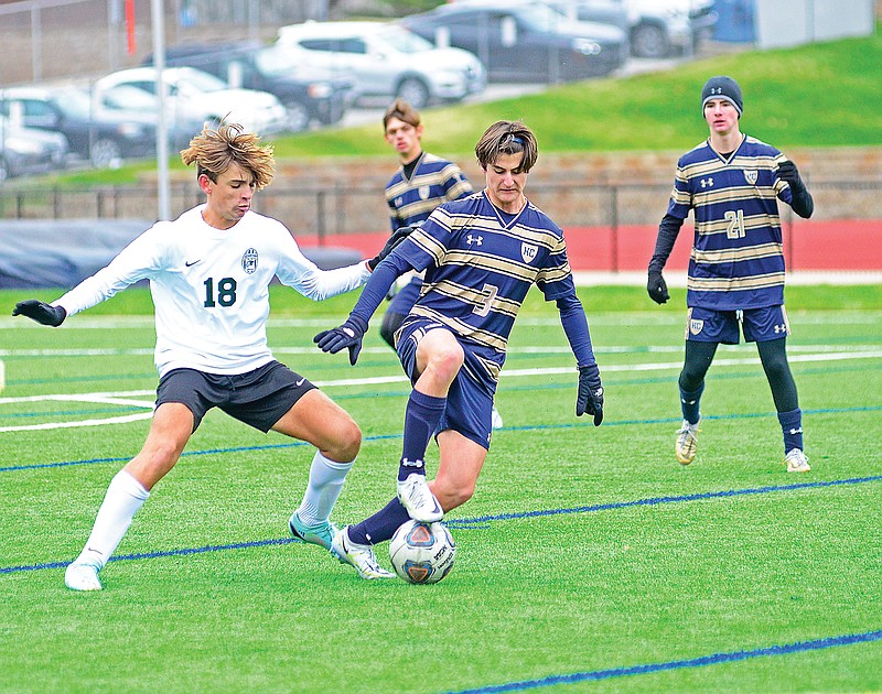 Jaxon Meller of Helias fight for possession of the ball against Orchard Farm’s Alexander Jeffords during Saturday’s Class 2 quarterfinal game at the Crusader Athletic Complex. (Eileen Wisniowicz/News Tribune)