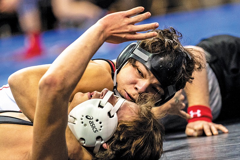 Jefferson City’s Cameron McKee works to pin Fort Zumwalt East’s Kaiden Brooks during their first-round match at 138 pounds earlier this year in the Class 3 state wrestling championships at Mizzou Arena in Columbia. (News Tribune file photo)