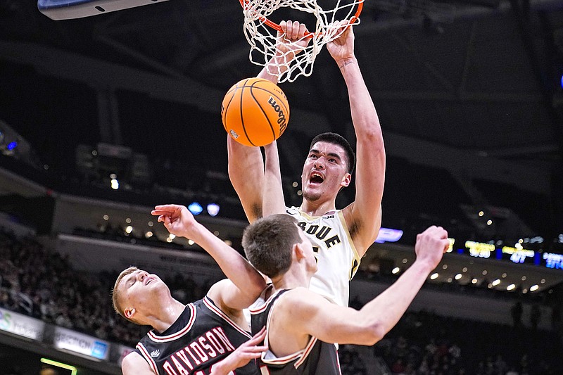 Purdue center Zach Edey dunks the ball over Davidson forward David Skogman (left) and forward Sean Logan in the first half of Saturday's game in Indianapolis. (Associated Press)