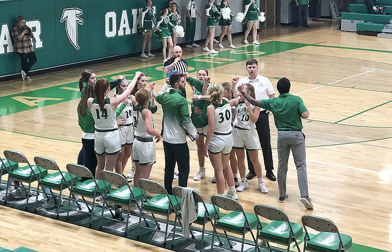 The Blair Oaks Lady Falcons get ready to break down a huddle on their bench during a timeout in Wednesday's game against Southern Boone at Blair Oaks High School in Wardsville. (Tom Rackers/News Tribune)