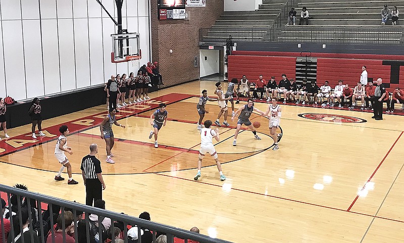 Jefferson City's Cole Heller (right) passes the ball to his teammate, Tripp Maassen (1), during Thursday night's game against Lutheran: St. Charles at Fleming Fieldhouse. (Greg Jackson/News Tribune)