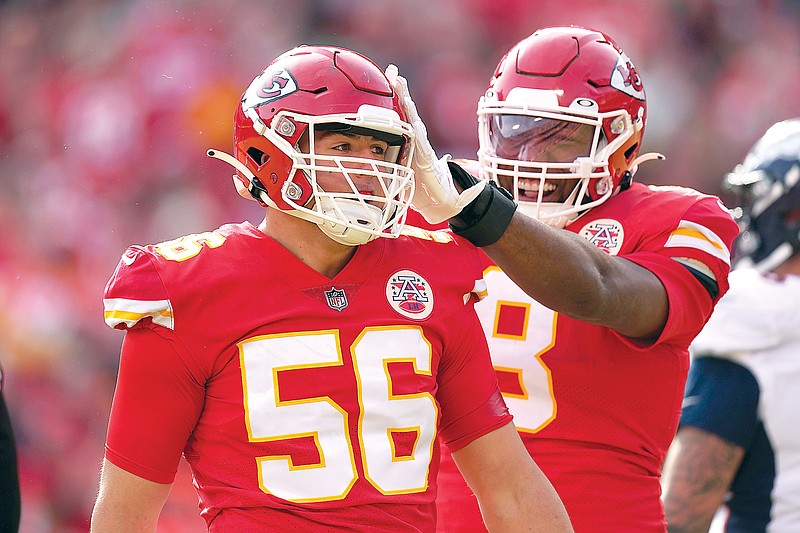 Chiefs defensive end George Karlaftis is congratulated by teammate Carlos Dunlap after sacking Broncos quarterback Russell Wilson during a game earlier this month at Arrowhead Stadium in Kansas City. (Associated Press)