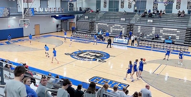 The Capital City Cavaliers and the Hermann Bearcats warm up on the court before the start of Tuesday night's game at Capital City High School. (Kyle McAreavy/News Tribune)