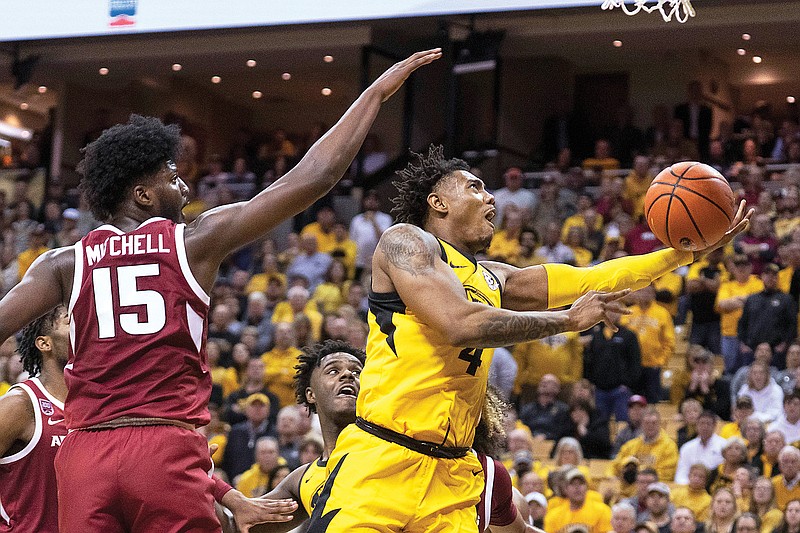 Missouri’s DeAndre Gholston shoots the ball past Makhi Mitchell of Arkansas during the second half of Wednesday night’s game at Mizzou Arena in Columbia. (Associated Press)