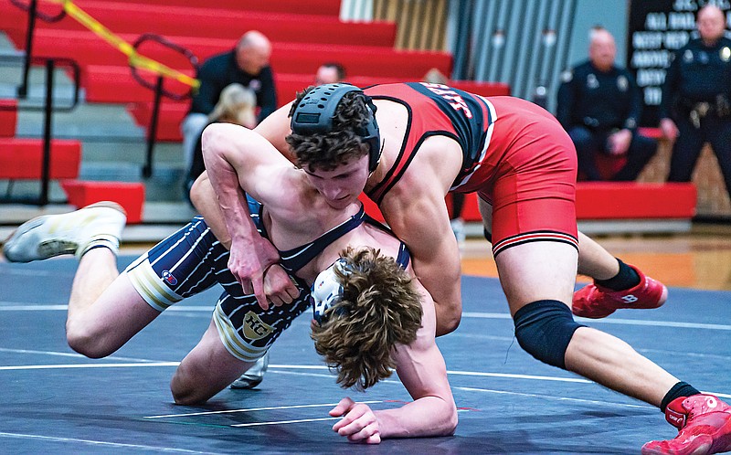 Jefferson City’s Luke Mosley tries to score a takedown against Dugan Williams of Helias during their 165-pound match in Wednesday night’s dual at Fleming Fieldhouse. (Ken Barnes/News Tribune)