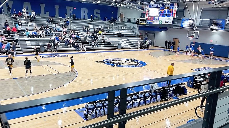 The Capital City Lady Cavaliers and the Sullivan Lady Eagles warm up on the court before the start of Thursday night's game at Capital City High School. (Kyle McAreavy/News Tribune)